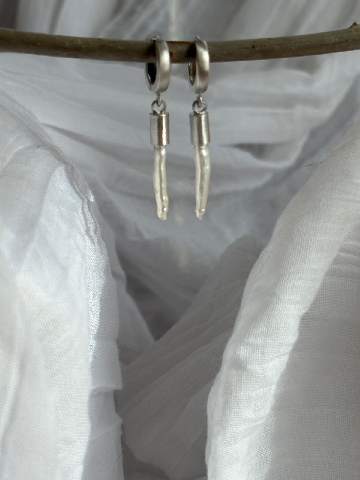 palisades.  white freshwater toothpick pearls with sterling silver huggie hoops.