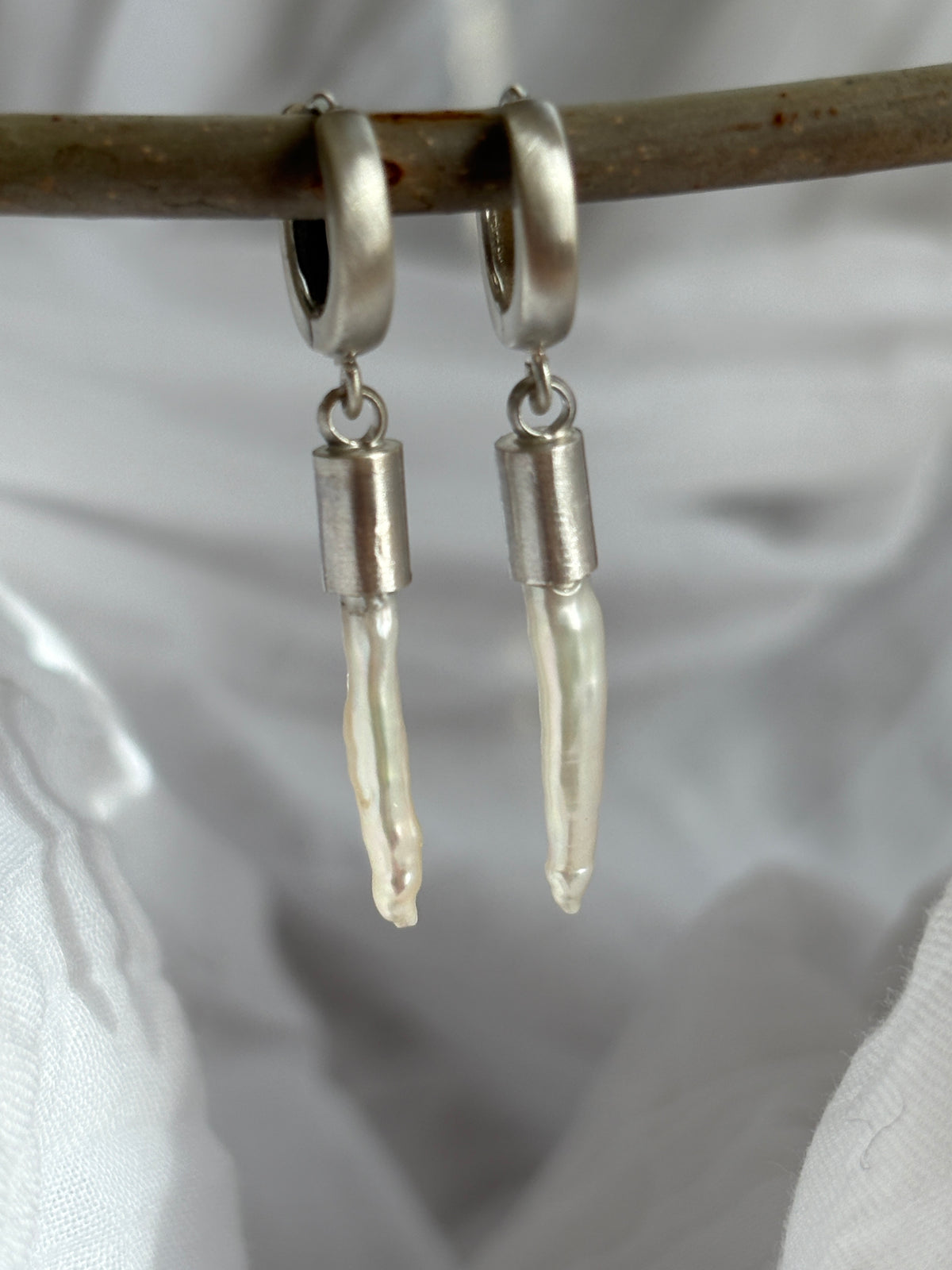 palisades.  white freshwater toothpick pearls with sterling silver huggie hoops.