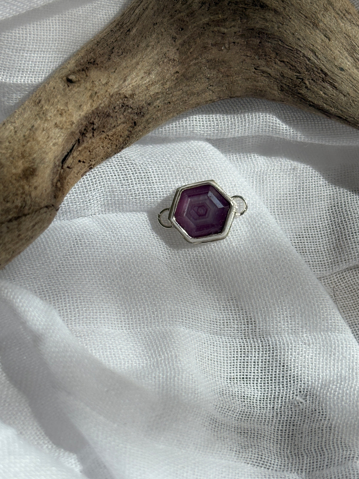 growth.  a hexagonal pink sapphire slice set in sterling silver. permanent jewelry connector or custom bracelet.